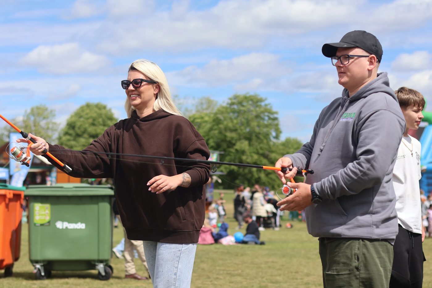 An adult learning to cast at a community event