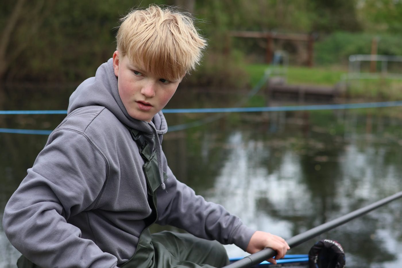 A young angler concentrating on the pole