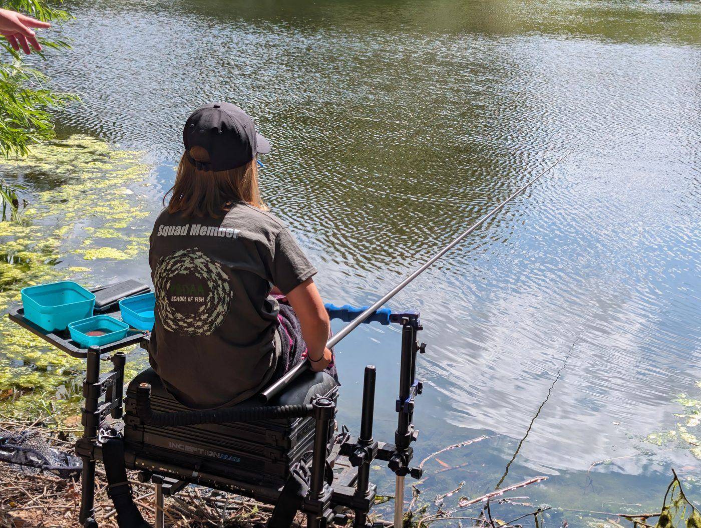 A Squad member fishing the pole from the box with bait trays set out