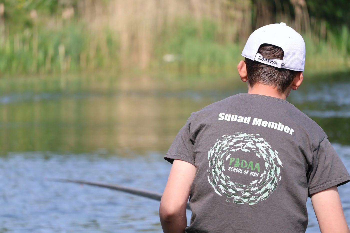 A young squad member fishing beside the reeds