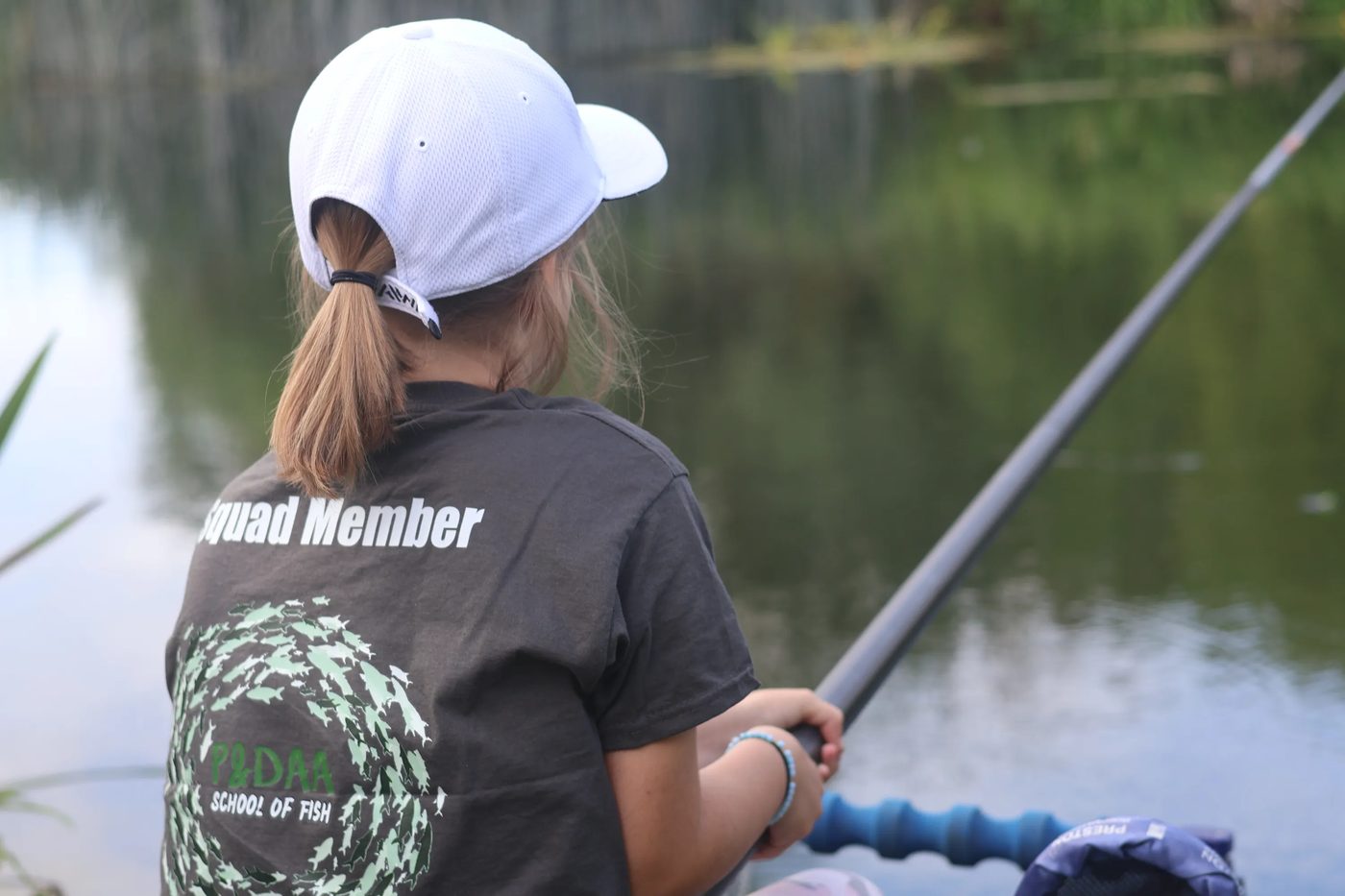 A young squad member fishing with a pole